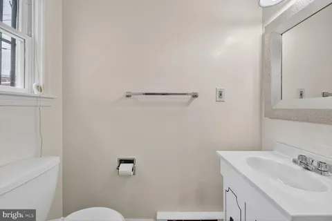 a bathroom with a sink a toilet and vanity