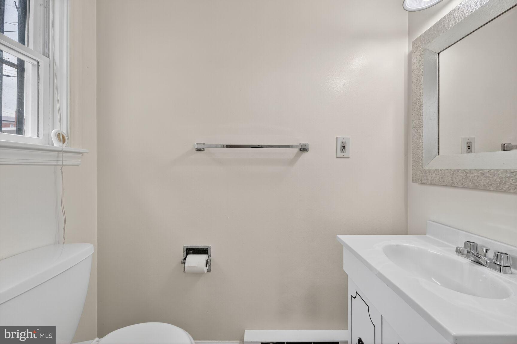 5720 5th Street Northeast Washington, DC 20011 - Photo 10 of 24 a bathroom with a sink a toilet and vanity