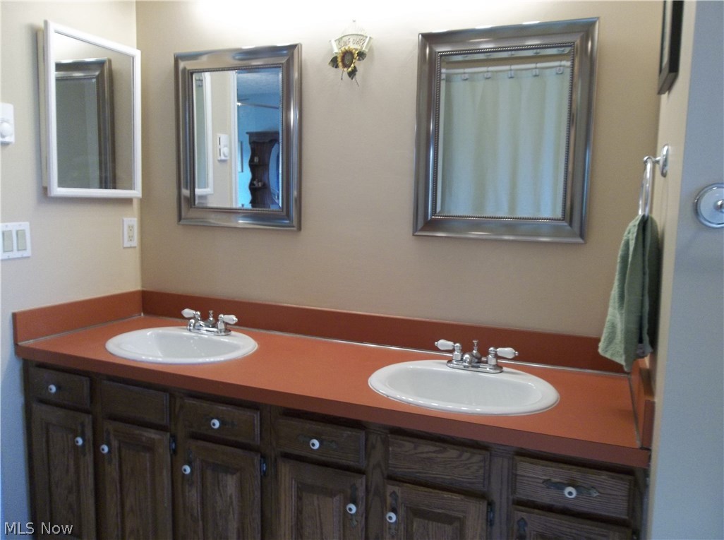 70 Boulder Ridge Place Painesville, OH 44077 - Photo 14 of 26 Double sink in the full bathroom with two new mirrors, medicine cabinet, plenty of storage in the vanity & many towel bars!