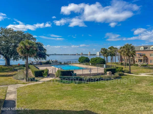 a view of a swimming pool with a lake from a balcony