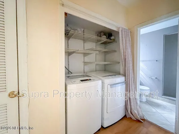 a bathroom with a sink and a wooden floor
