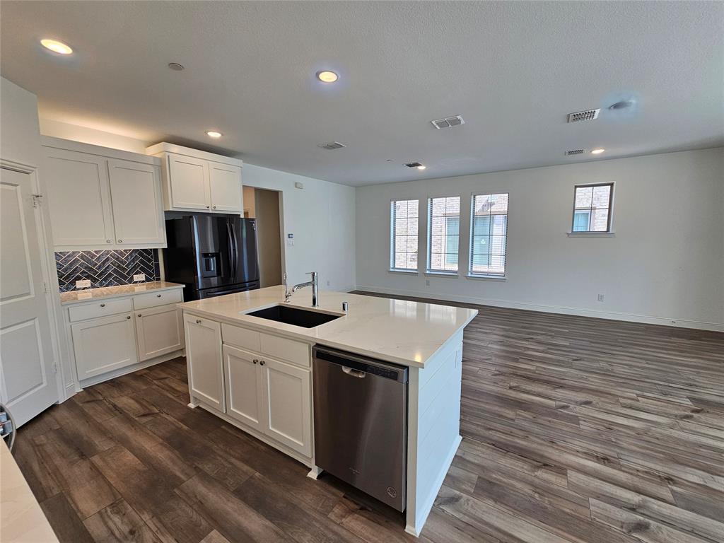 7280 Panicum Drive Frisco, TX 75033 - Photo 11 of 36 a kitchen with a stove a sink and a refrigerator