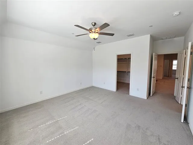 a spacious bathroom with double sink and a mirror