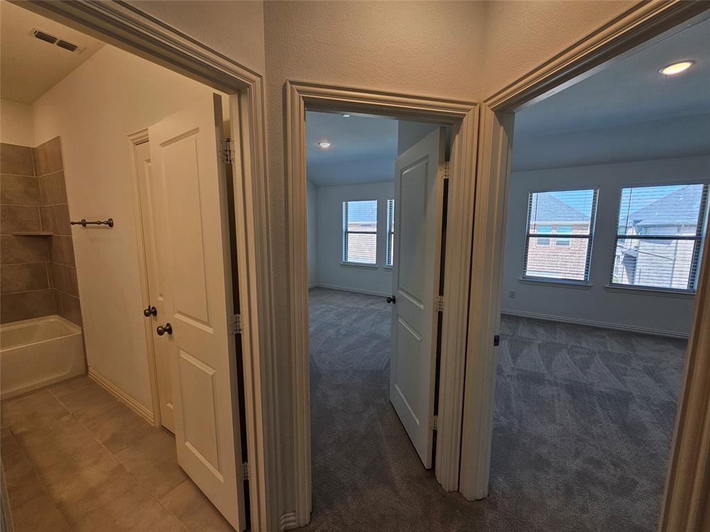 7280 Panicum Drive Frisco, TX 75033 - Photo 24 of 36 a view of a bathroom with a glass door and shower