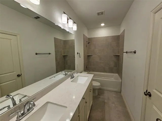 a bathroom with a sink mirror and vanity