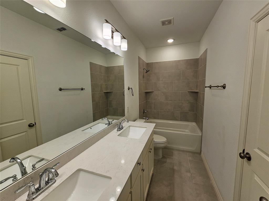 7280 Panicum Drive Frisco, TX 75033 - Photo 25 of 36 a bathroom with a tub sink and mirror