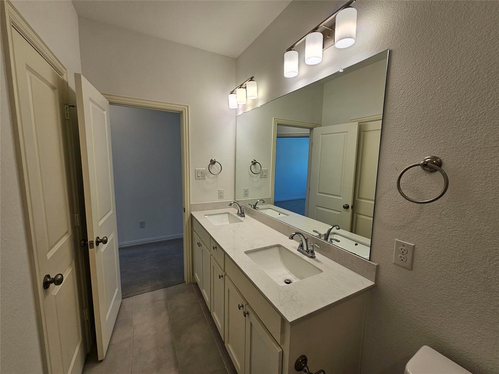 7280 Panicum Drive Frisco, TX 75033 - Photo 27 of 36 a bathroom with a sink mirror and vanity