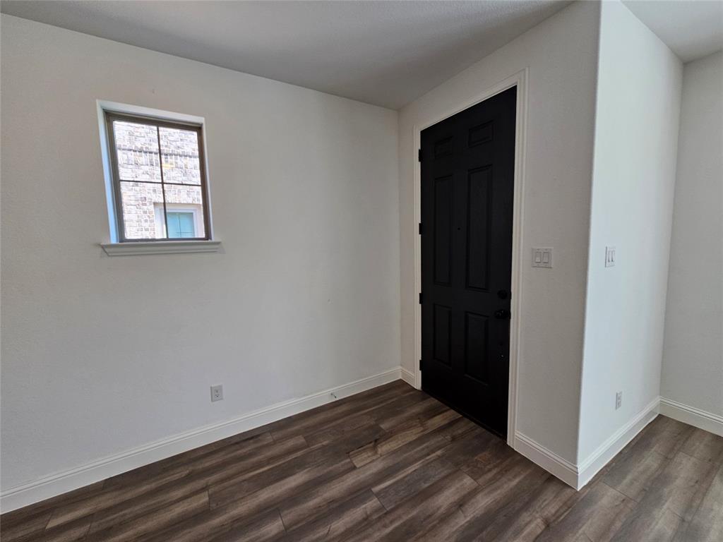 7280 Panicum Drive Frisco, TX 75033 - Photo 4 of 36 an empty room with wooden floor closet and windows