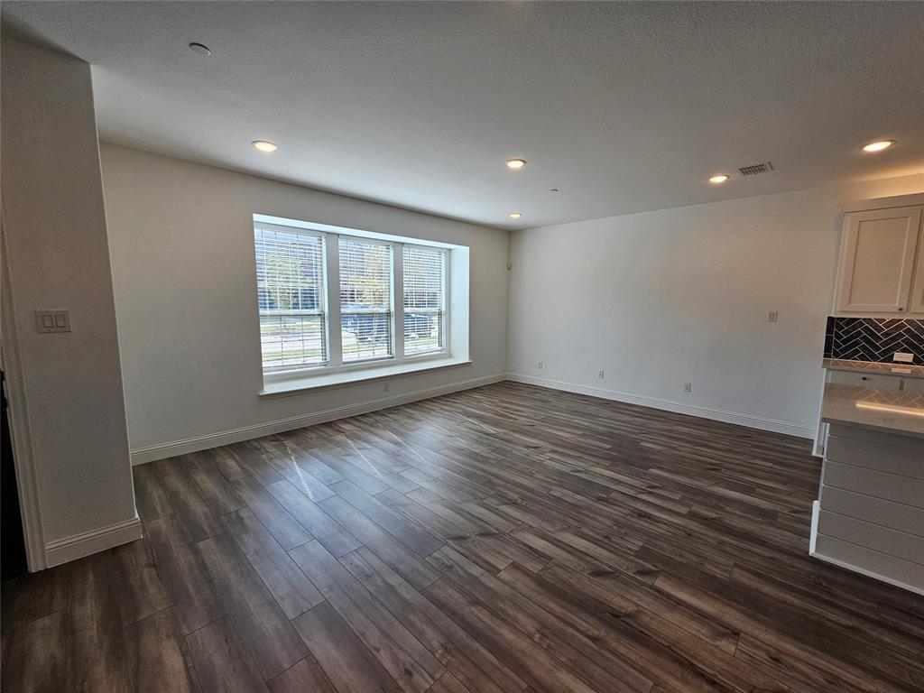 7280 Panicum Drive Frisco, TX 75033 - Photo 6 of 36 an empty room with wooden floor and windows