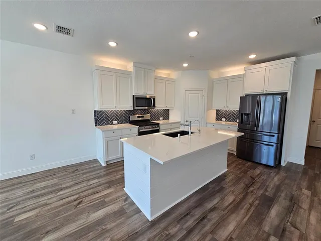 a kitchen with a refrigerator and window