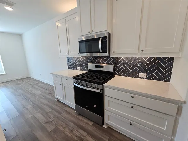 a kitchen with a stove a sink and a refrigerator