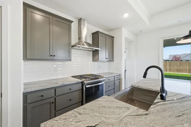 a kitchen with stainless steel appliances kitchen island a sink and a refrigerator