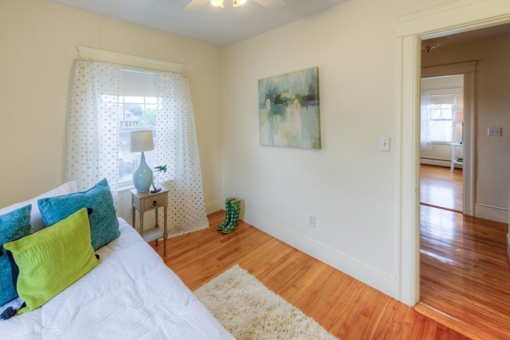 5 Bellingham Road Worcester, MA 01606 - Photo 20 of 30 a bedroom with a bed and a wooden floor