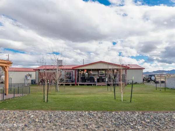 a view of a house with backyard and barbeque area