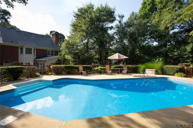 a view of a swimming pool with a patio