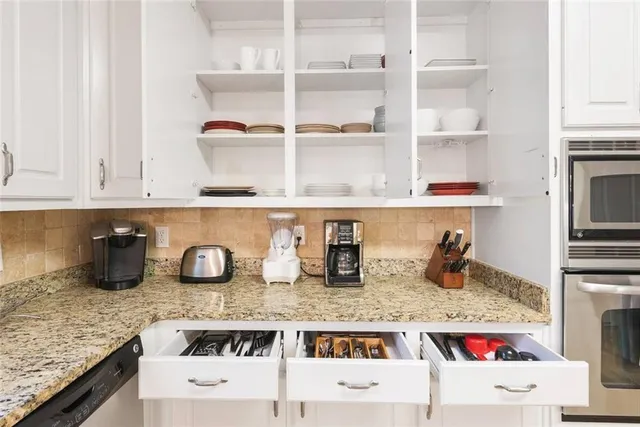 a cabinet with white cabinets and wooden floor