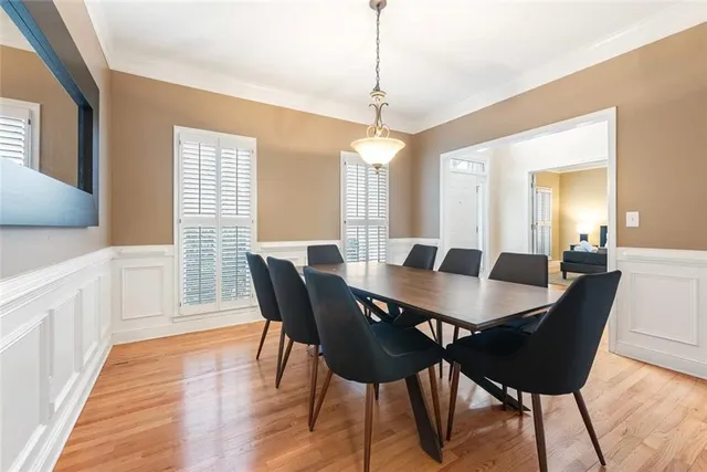 a view of a a dining room with furniture window and wooden floor