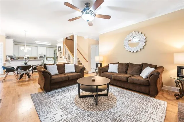 a living room with furniture a rug and a chandelier
