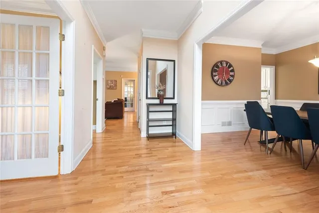 a view of a hallway with furniture and wooden floor