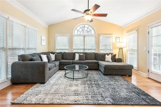 a living room with furniture and a chandelier