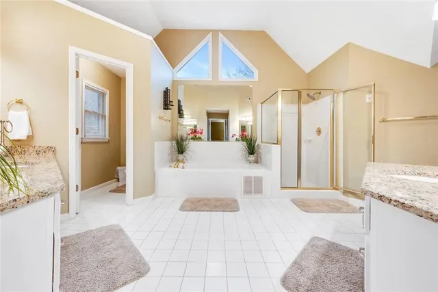 a bathroom with a tub sink and mirror