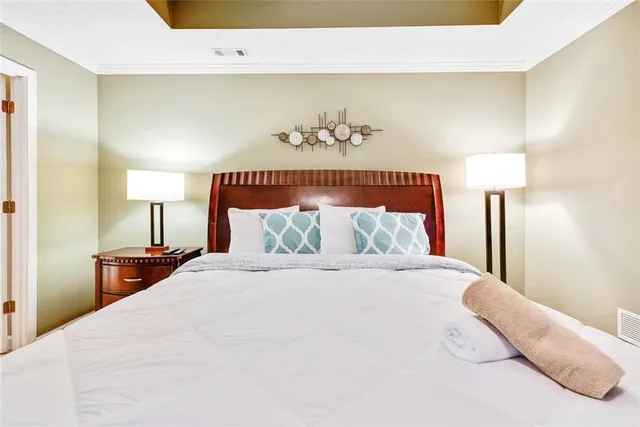 a bedroom with a bed and a lamp