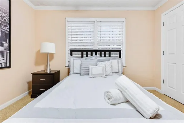 a bedroom with a bed and a lamp