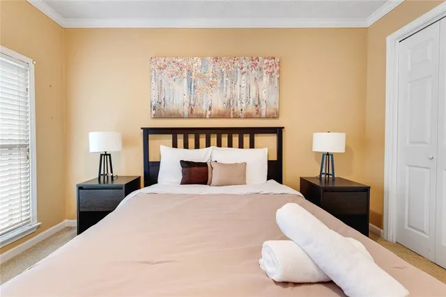 a bedroom with a bed and a lamp on table