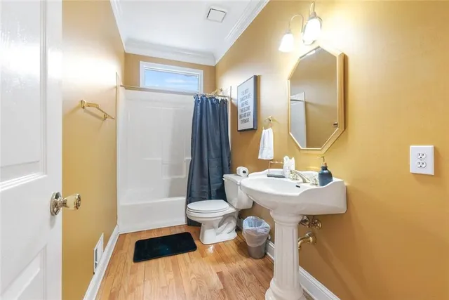 a bathroom with a sink mirror toilet and shower