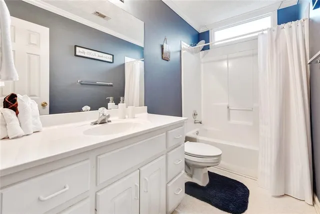 a bathroom with a sink a toilet a mirror and shower