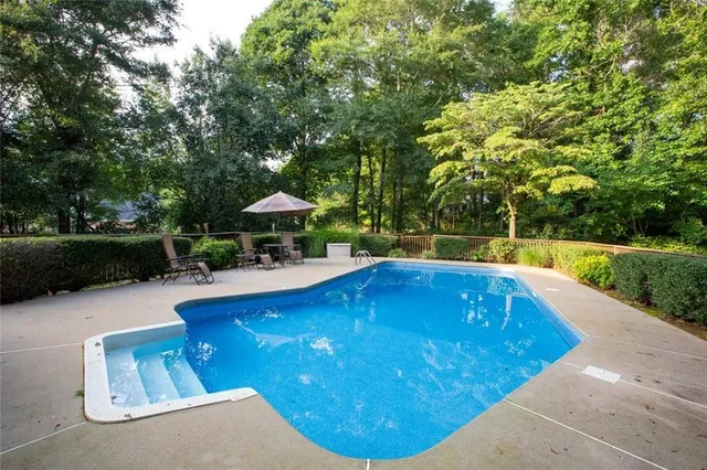 a view of a swimming pool with a patio