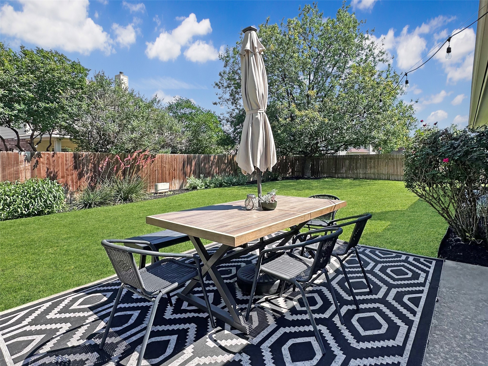 20213 Kearney Hill Road Pflugerville, TX 78660 - Photo 25 of 27 An inviting backyard oasis offers ample green space and a perfect patio for alfresco dining.
