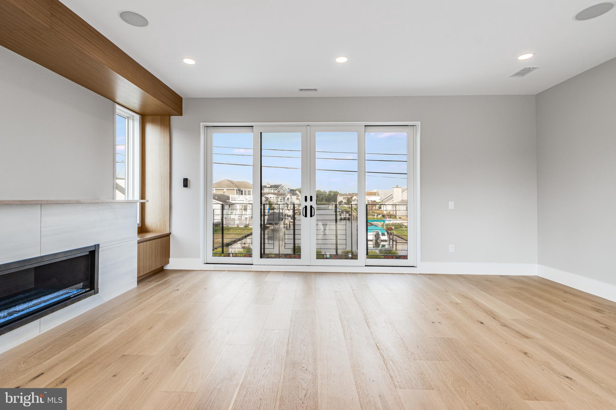 316 York Road Bethany Beach, DE 19930 - Photo 17 of 104 an empty room with wooden floor and fireplace