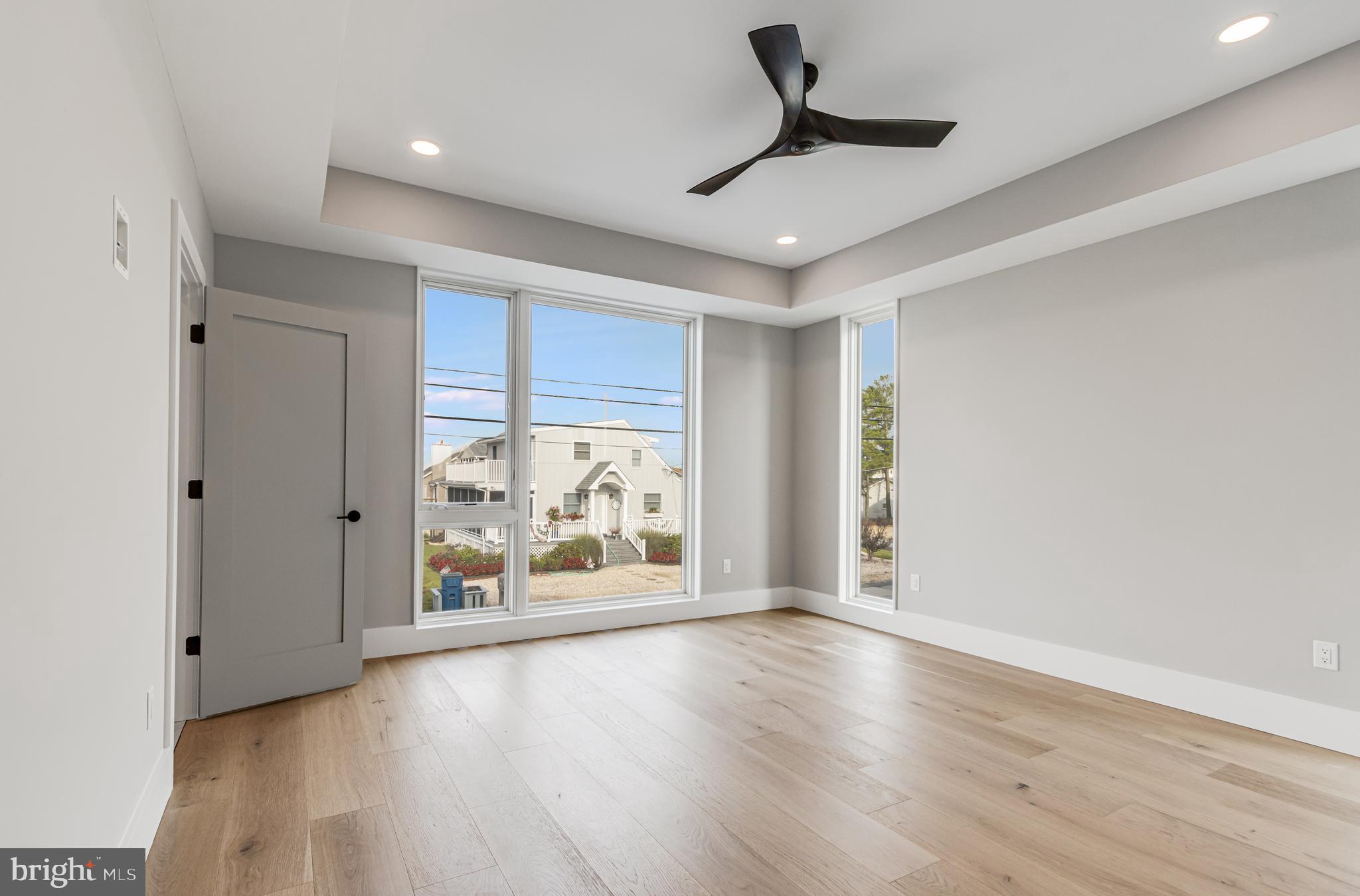 316 York Road Bethany Beach, DE 19930 - Photo 26 of 104 a view of an empty room with wooden floor and a window