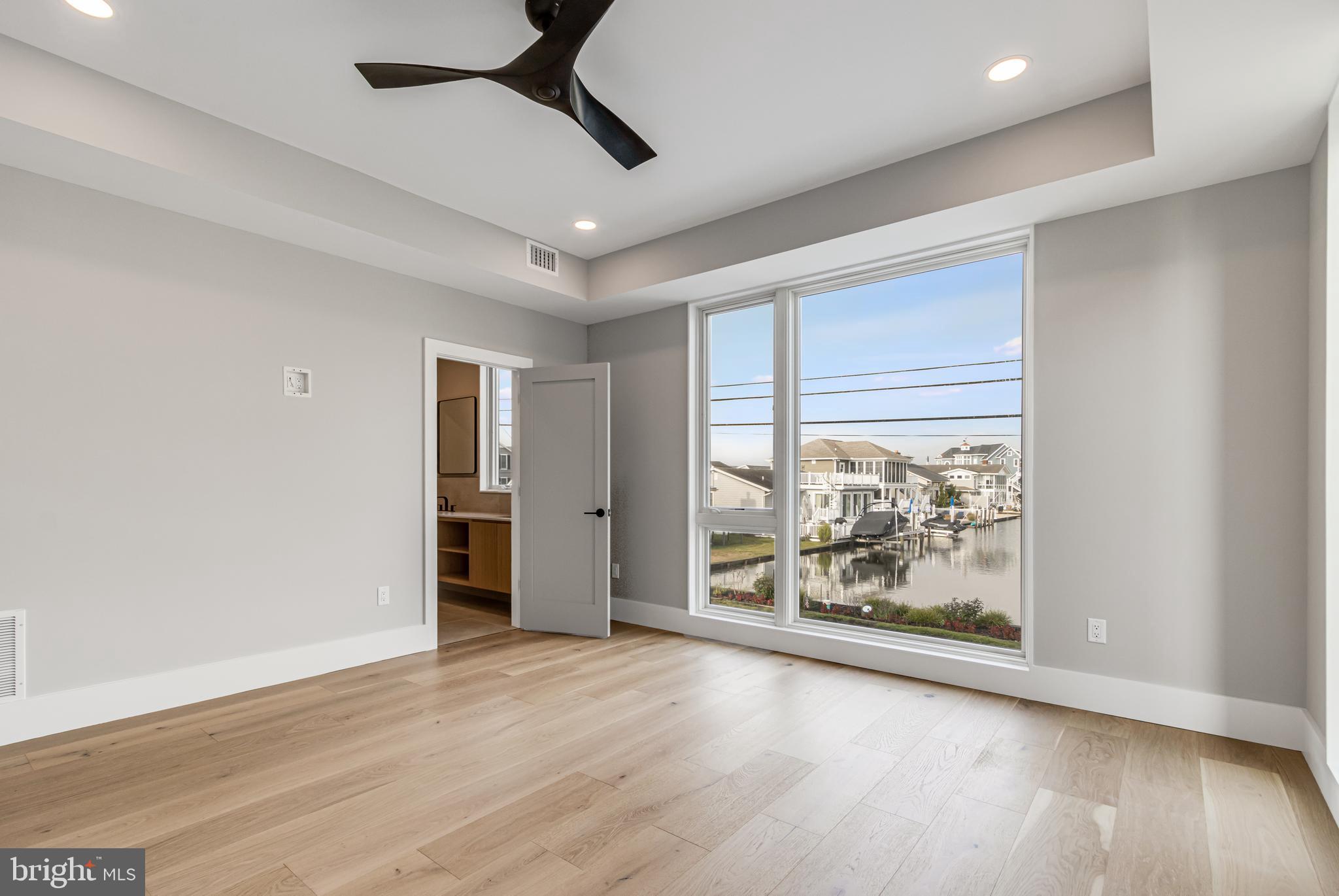 316 York Road Bethany Beach, DE 19930 - Photo 27 of 104 wooden floor in an empty room with a window