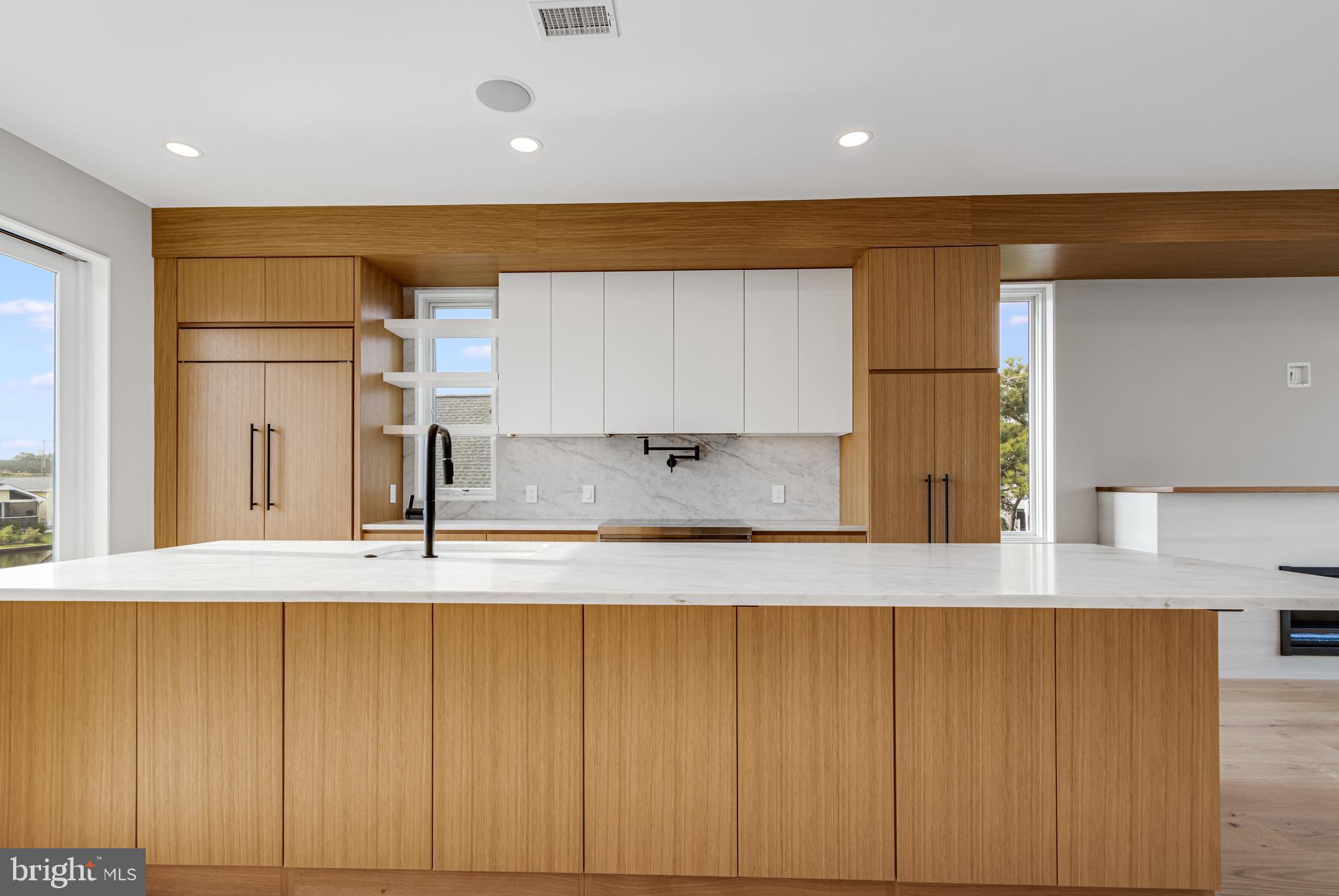 316 York Road Bethany Beach, DE 19930 - Photo 3 of 104 a view of a kitchen with wooden floor and electronic appliances