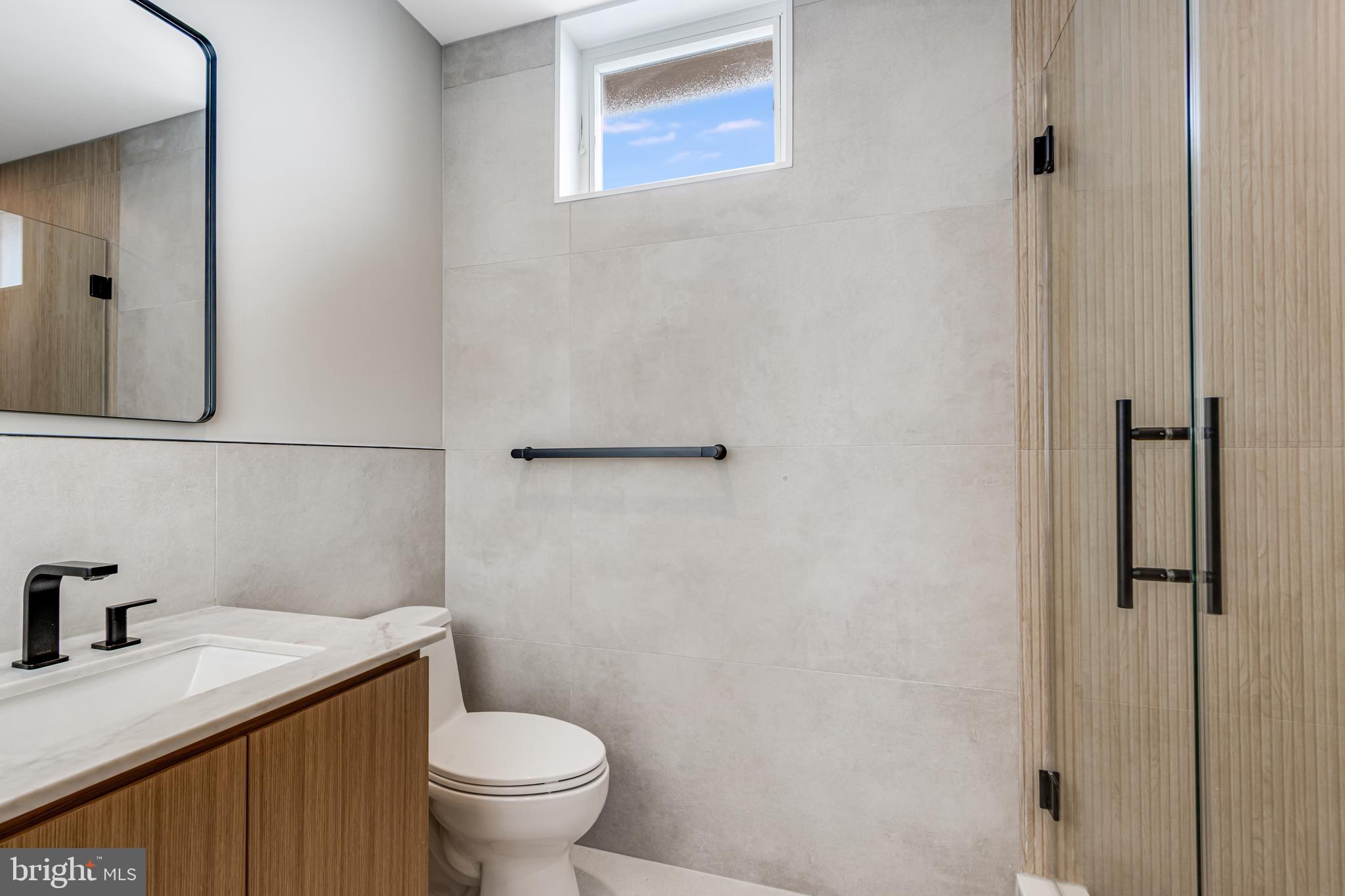 316 York Road Bethany Beach, DE 19930 - Photo 34 of 104 a bathroom with a granite countertop toilet and a sink