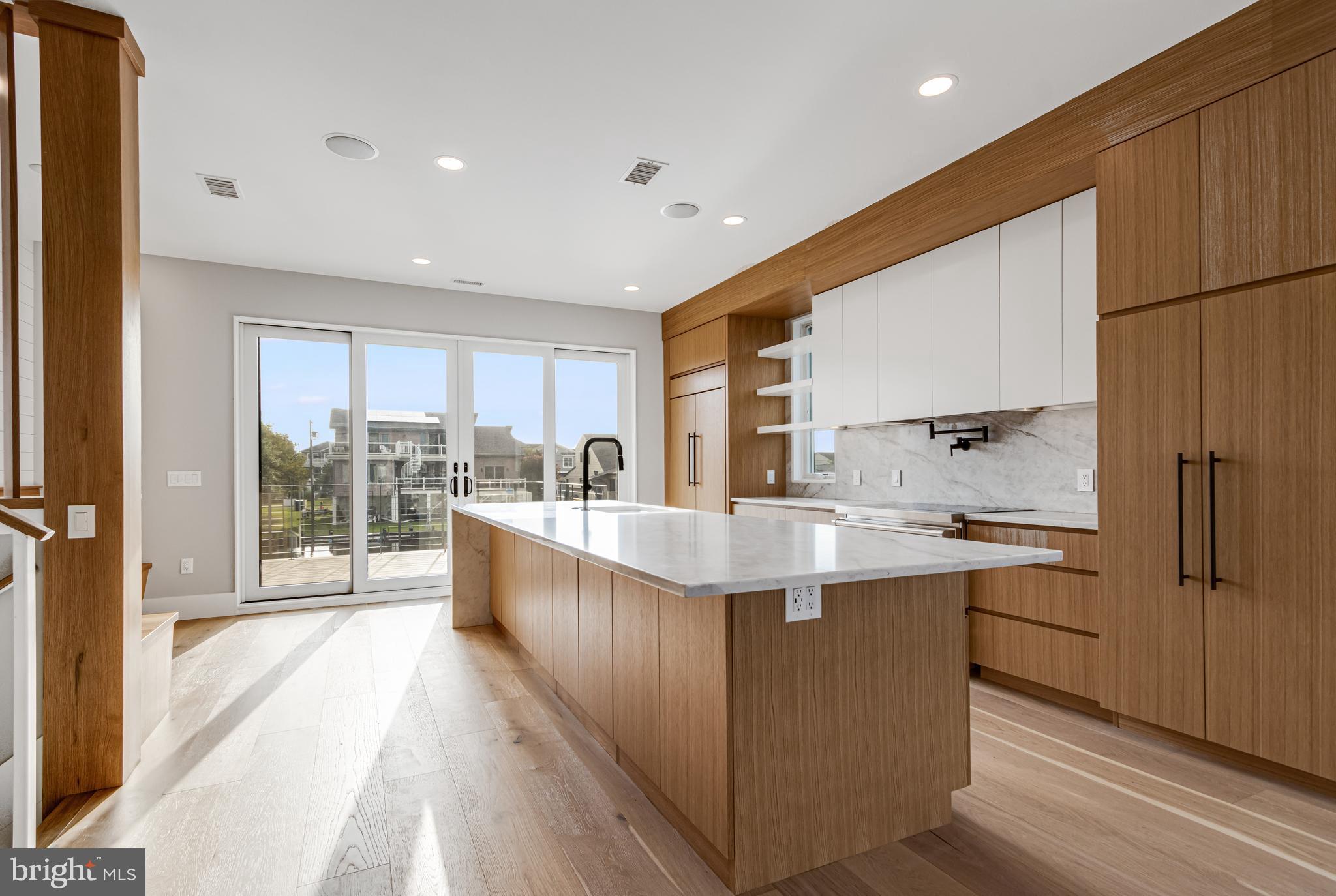 316 York Road Bethany Beach, DE 19930 - Photo 4 of 104 a large kitchen with stainless steel appliances a large window and a counter space