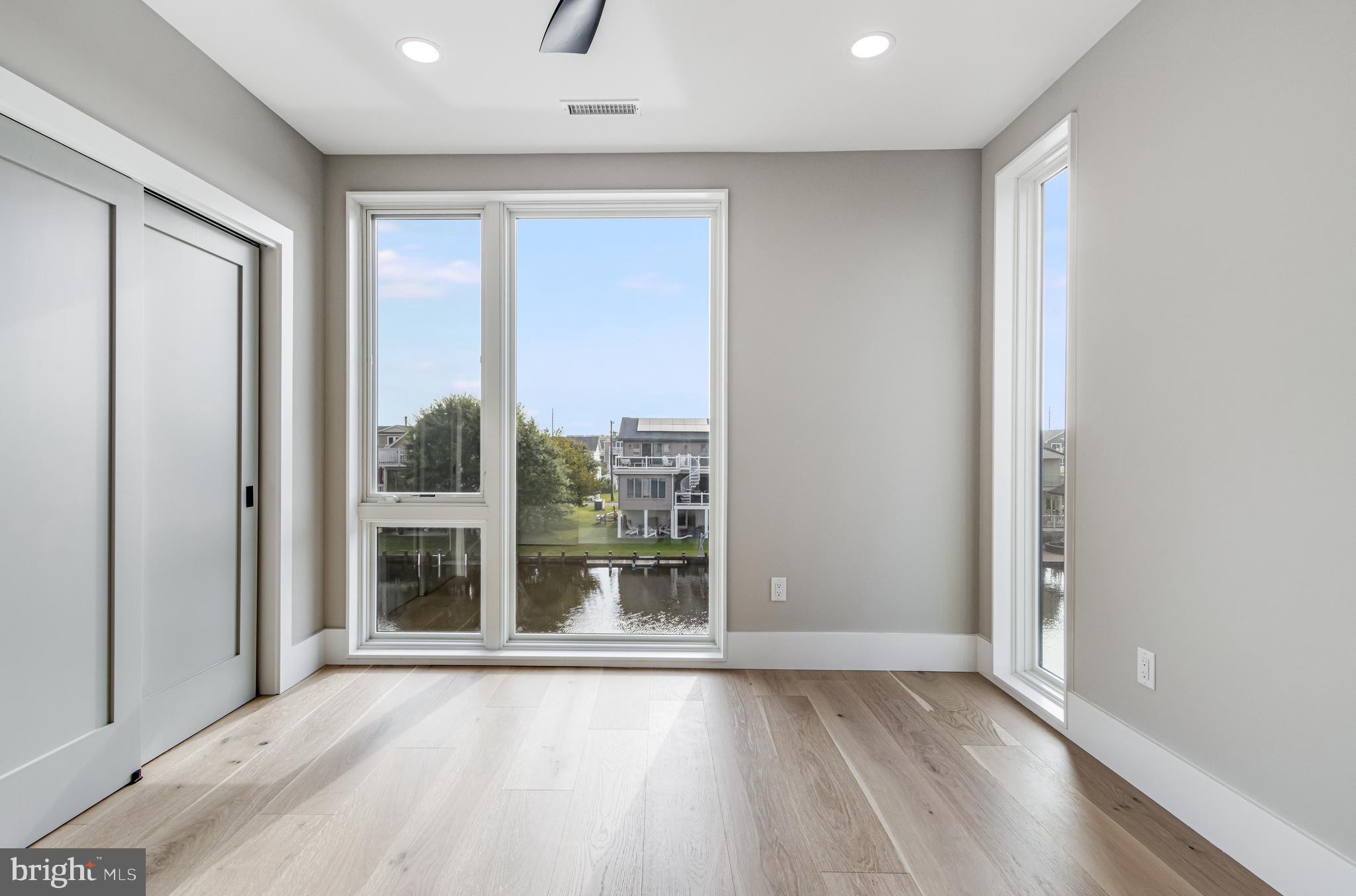 316 York Road Bethany Beach, DE 19930 - Photo 42 of 104 an empty room with wooden floor and windows
