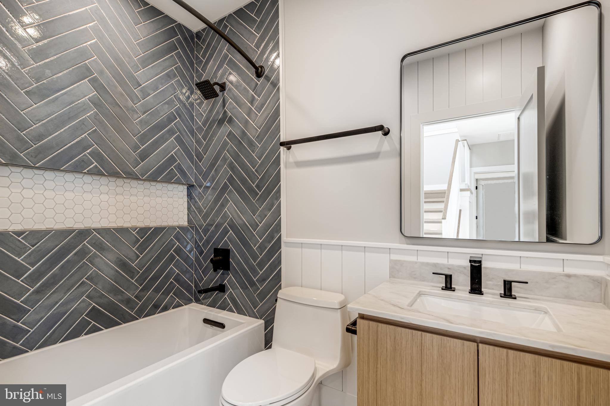 316 York Road Bethany Beach, DE 19930 - Photo 46 of 104 a bathroom with a bathtub sink vanity mirror and toilet