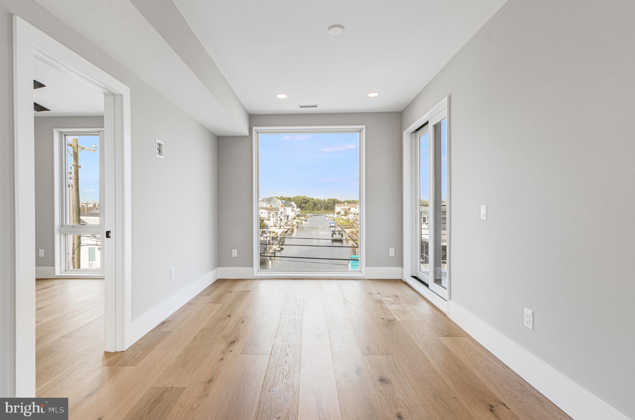 316 York Road Bethany Beach, DE 19930 - Photo 48 of 104 wooden floor in an empty room with a window