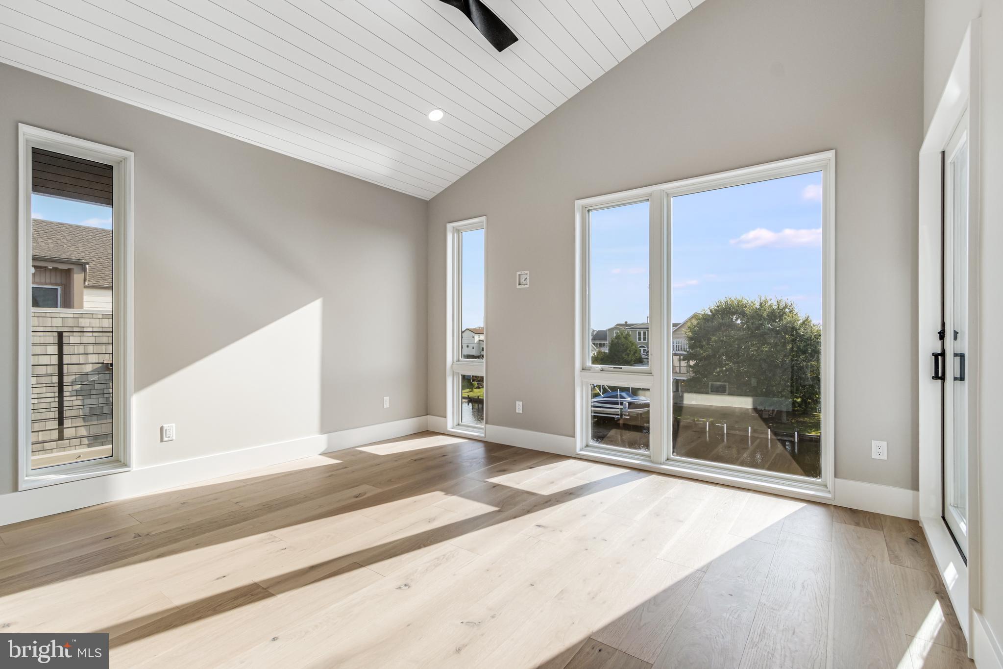 316 York Road Bethany Beach, DE 19930 - Photo 71 of 104 a bedroom with a bed and a large window with outer view