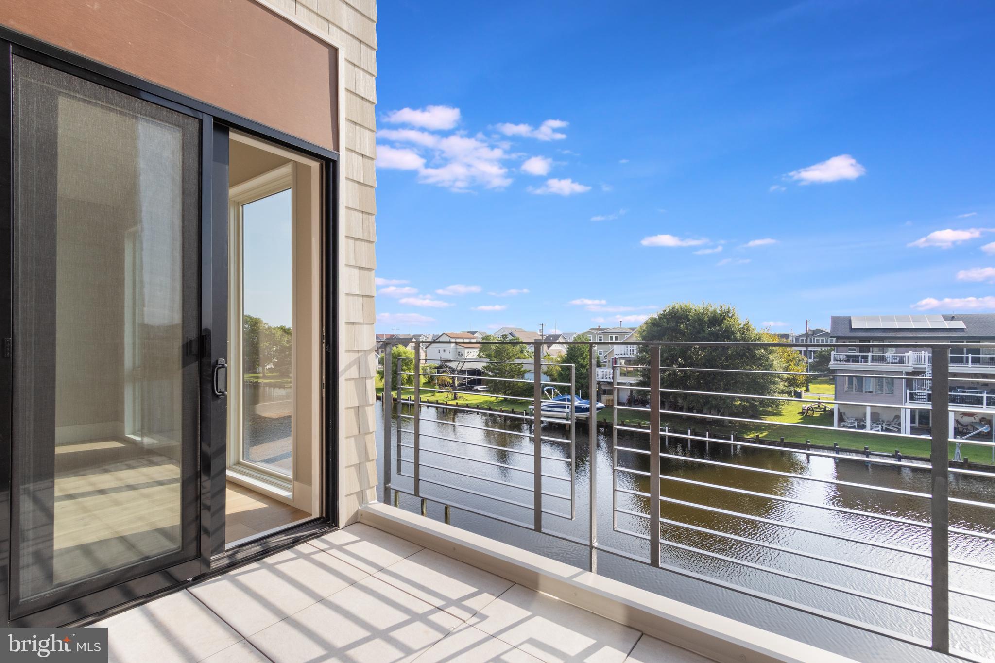 316 York Road Bethany Beach, DE 19930 - Photo 78 of 104 a view of a balcony with floor to ceiling windows with wooden floor