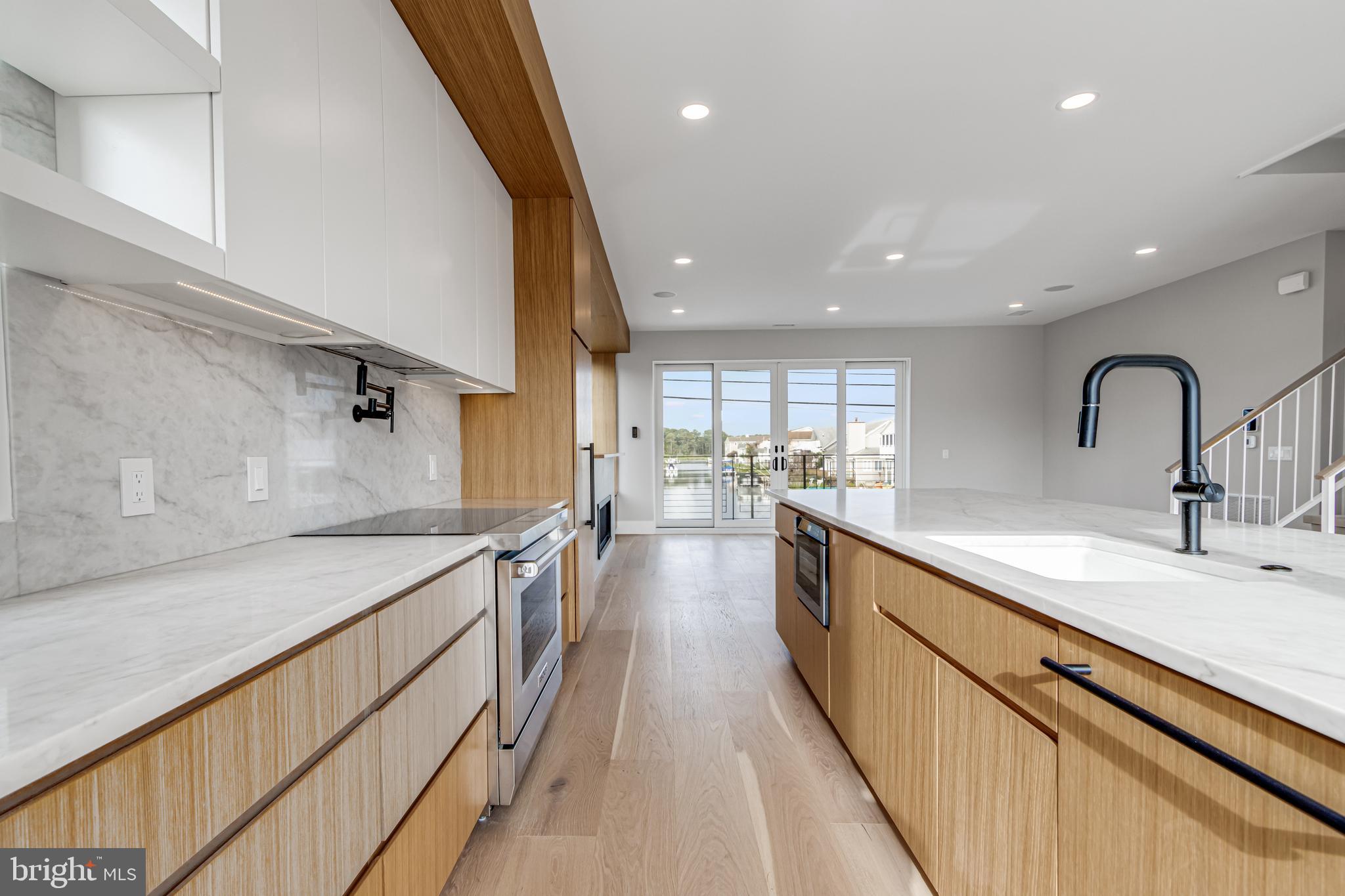 316 York Road Bethany Beach, DE 19930 - Photo 9 of 104 a view of a kitchen with a sink and wooden floor
