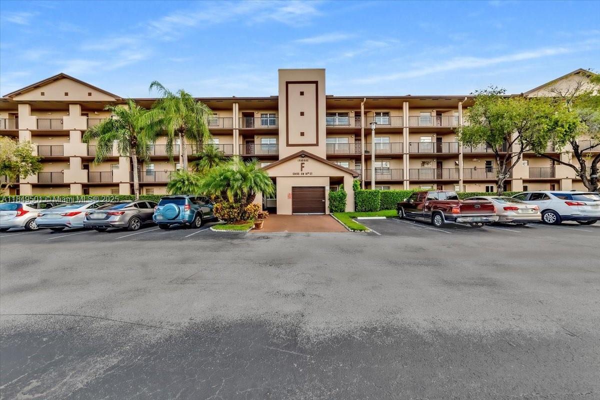 13455 Southwest 16th Court, Unit 104F Pembroke Pines, FL 33027 - Photo 20 of 53 a car parked in front of a building