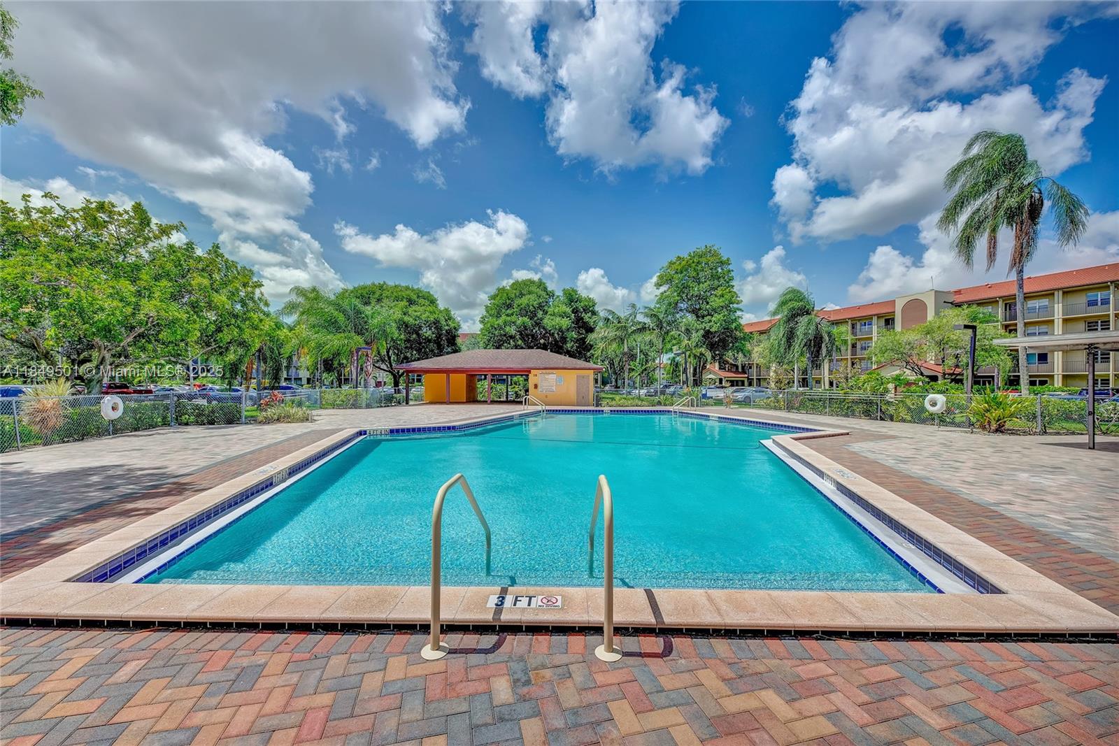 13455 Southwest 16th Court, Unit 104F Pembroke Pines, FL 33027 - Photo 30 of 53 a view of a tennis ground with a large trees
