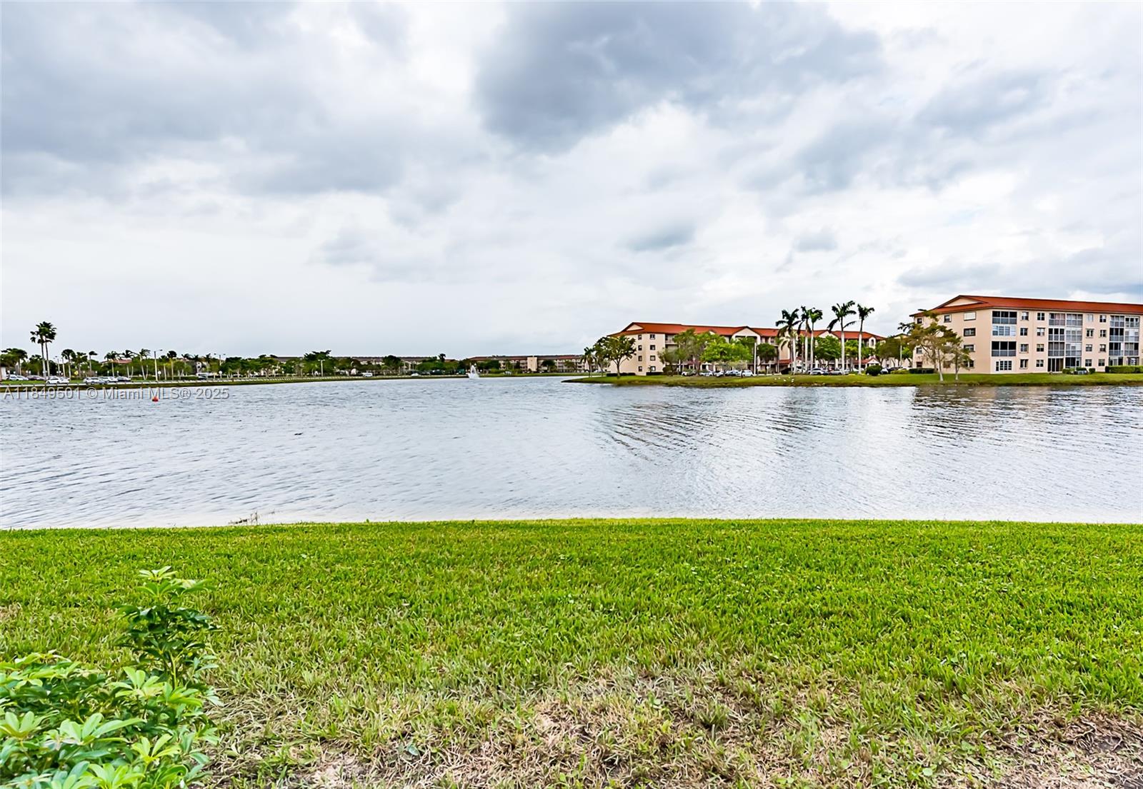 13455 Southwest 16th Court, Unit 104F Pembroke Pines, FL 33027 - Photo 42 of 53 a view of a lake with houses in the back