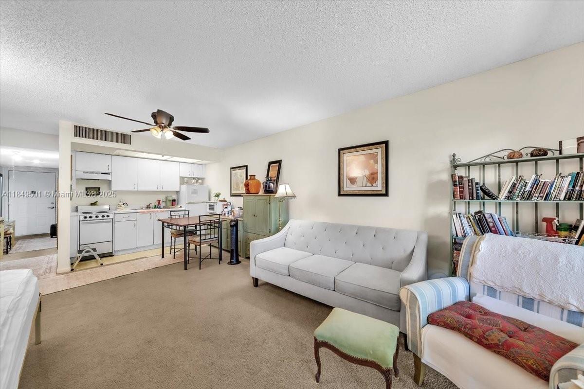 13455 Southwest 16th Court, Unit 104F Pembroke Pines, FL 33027 - Photo 5 of 53 a living room with furniture and a couch