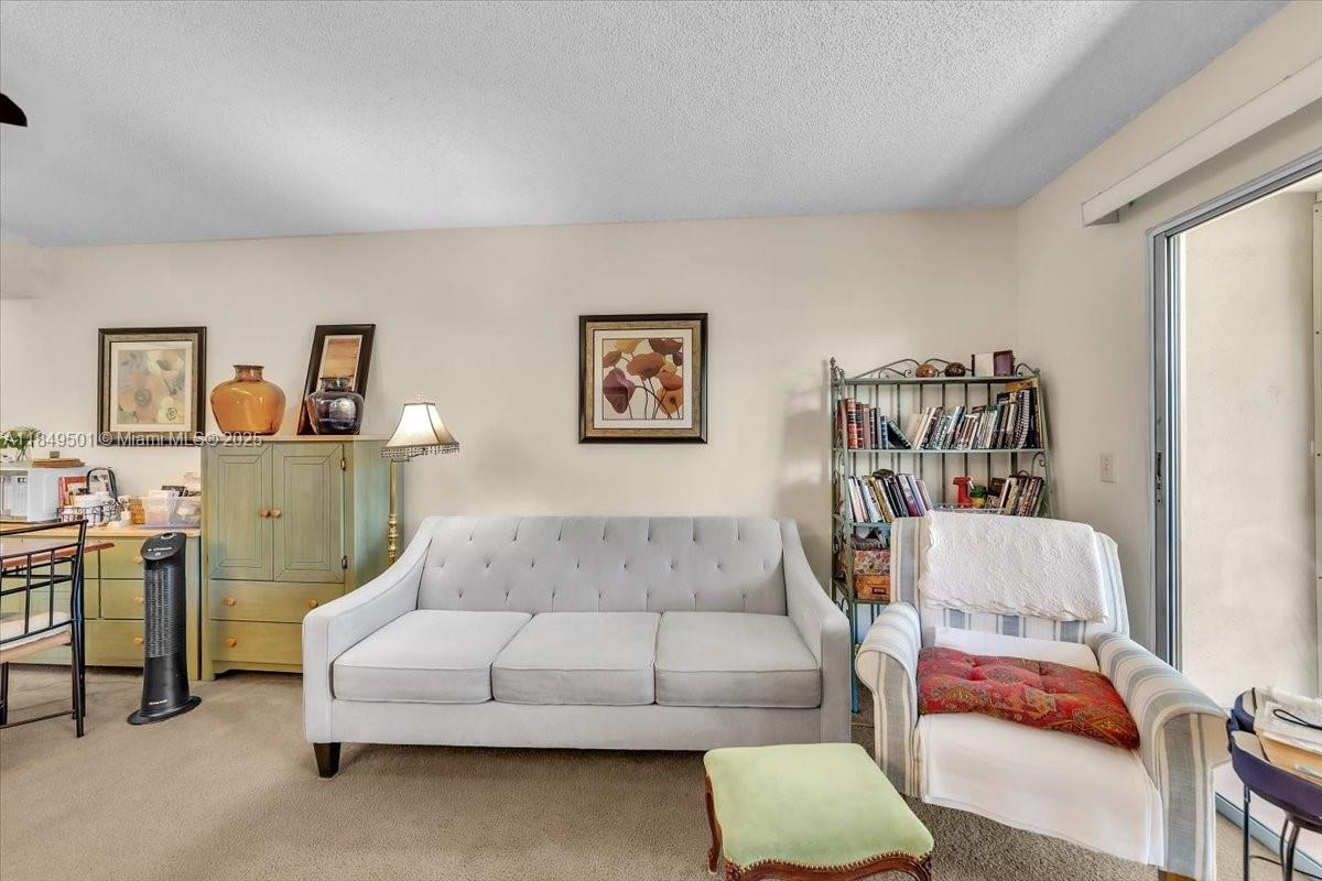 13455 Southwest 16th Court, Unit 104F Pembroke Pines, FL 33027 - Photo 7 of 53 a living room with furniture and a couch