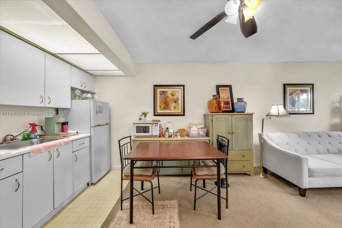 13455 Southwest 16th Court, Unit 104F Pembroke Pines, FL 33027 - Photo 9 of 53 a view of a dining room with furniture and chandelier